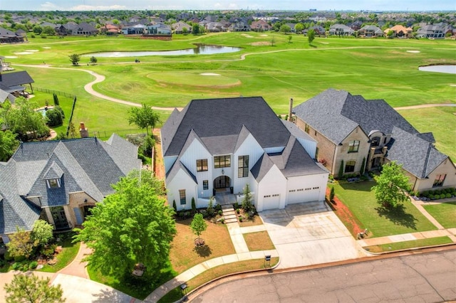 drone / aerial view featuring a residential view, a water view, and golf course view