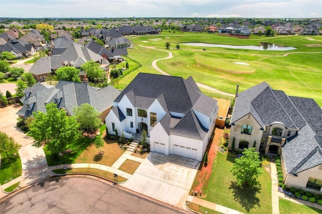 birds eye view of property with a water view, a residential view, and view of golf course