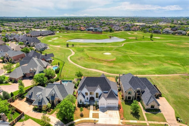 aerial view featuring golf course view, a water view, and a residential view