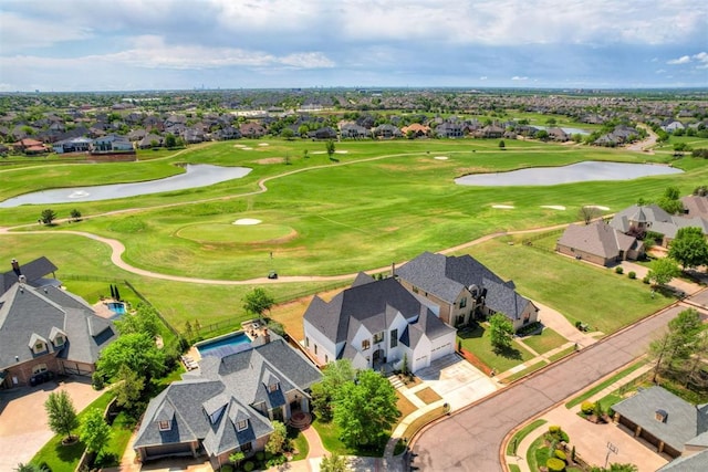 birds eye view of property featuring golf course view, a residential view, and a water view