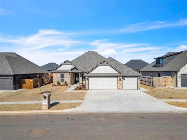 9213 NW 84th St, Yukon, OK 73099 - view of front of home with fence, driveway, brick siding, and an attached garage