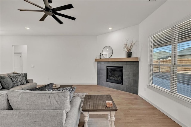 9213 NW 84th St, Yukon, OK 73099 - living room with recessed lighting, wood finished floors, a tile fireplace, baseboards, and a ceiling fan