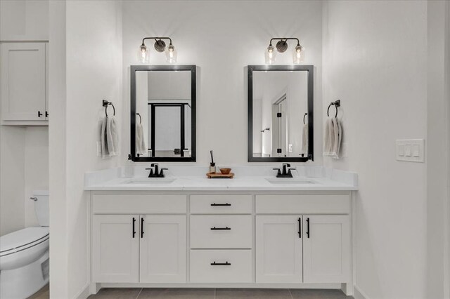 9213 NW 84th St, Yukon, OK 73099 - bathroom with double vanity, toilet, and a sink
