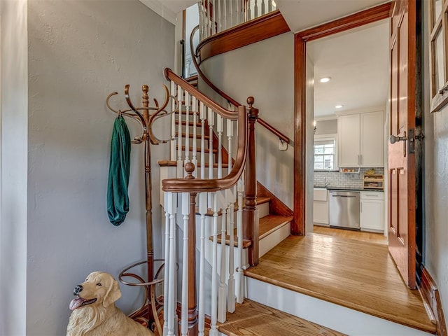 stairs featuring recessed lighting and wood finished floors