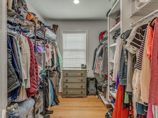 walk in closet with wood finished floors