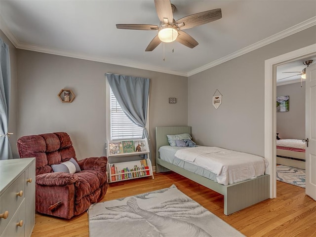 bedroom featuring crown molding, light wood finished floors, and ceiling fan