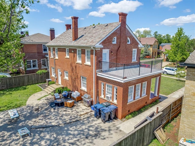 rear view of house with outdoor lounge area, brick siding, fence, and a chimney