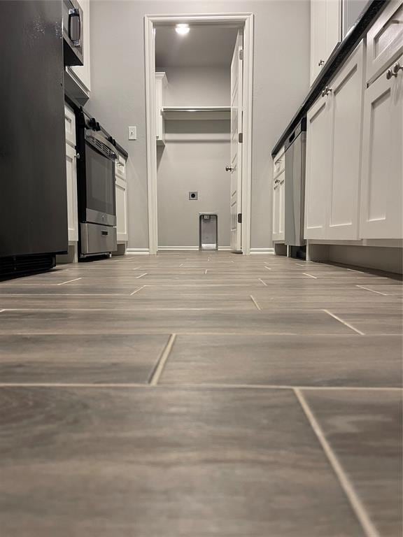 interior space featuring baseboards and light wood-style floors