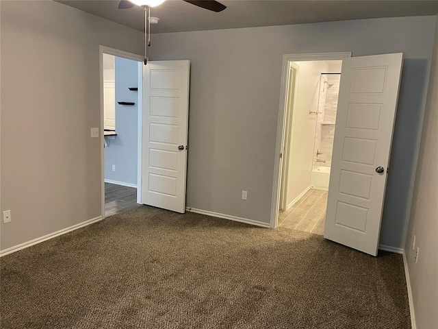 unfurnished bedroom with baseboards, carpet, and ensuite bathroom