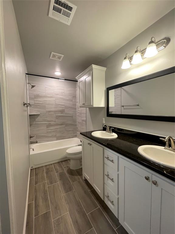 bathroom featuring visible vents, a sink, and toilet