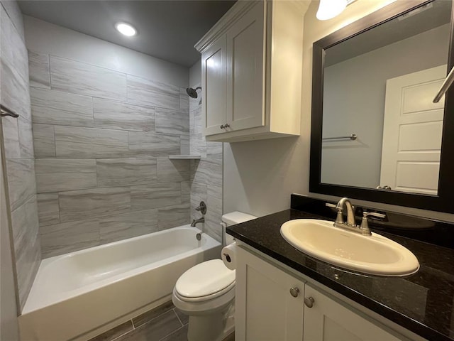 full bath with recessed lighting, vanity, bathtub / shower combination, and toilet