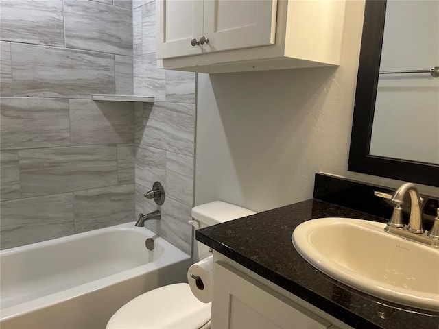 bathroom with vanity, toilet, and bathing tub / shower combination