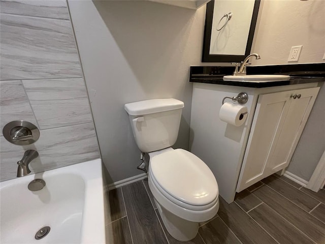 bathroom featuring baseboards, wood tiled floor, and toilet