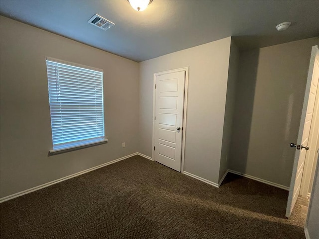 interior space featuring carpet floors, baseboards, and visible vents