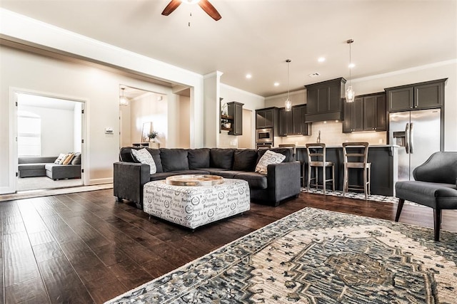 living room with ornamental molding, recessed lighting, ceiling fan, and dark wood-style flooring