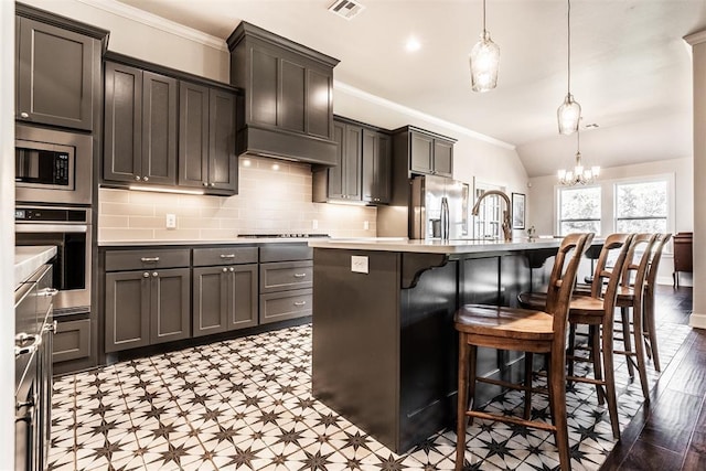 kitchen featuring crown molding, appliances with stainless steel finishes, visible vents, a chandelier, and tile patterned floors