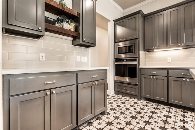 kitchen featuring light floors, open shelves, appliances with stainless steel finishes, light countertops, and crown molding