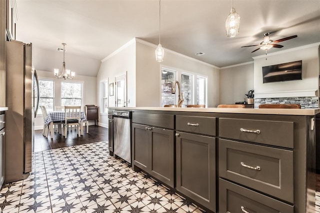 kitchen featuring a sink, light floors, decorative light fixtures, appliances with stainless steel finishes, and ceiling fan with notable chandelier