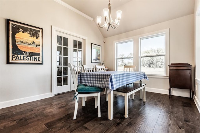dining room featuring a healthy amount of sunlight, a notable chandelier, dark wood-style flooring, and lofted ceiling
