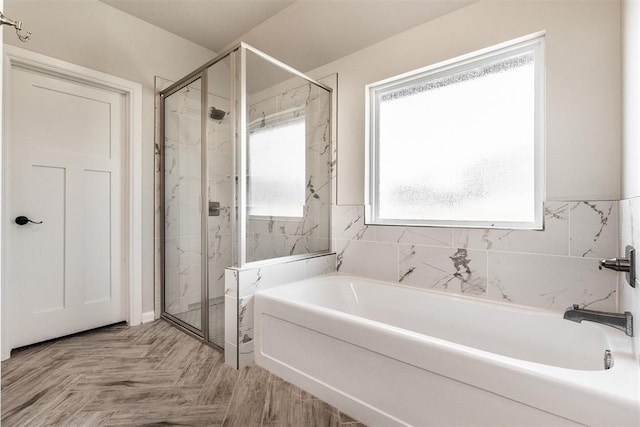 full bath featuring a shower stall and a garden tub