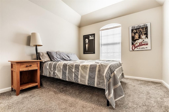 carpeted bedroom with baseboards and lofted ceiling
