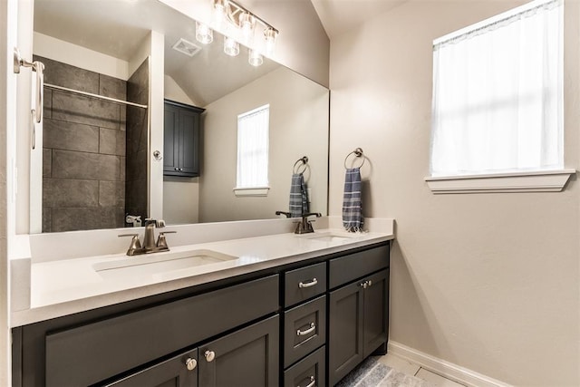 full bathroom featuring double vanity, a sink, baseboards, and visible vents