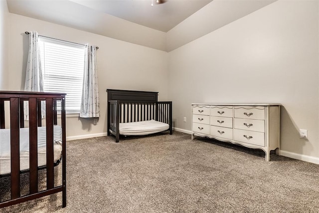carpeted bedroom with lofted ceiling and baseboards