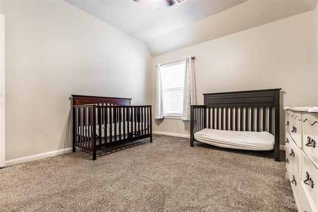 carpeted bedroom with lofted ceiling, ceiling fan, and baseboards