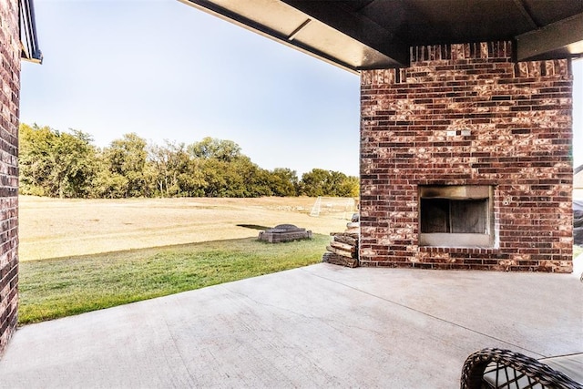 view of patio / terrace featuring an outdoor brick fireplace