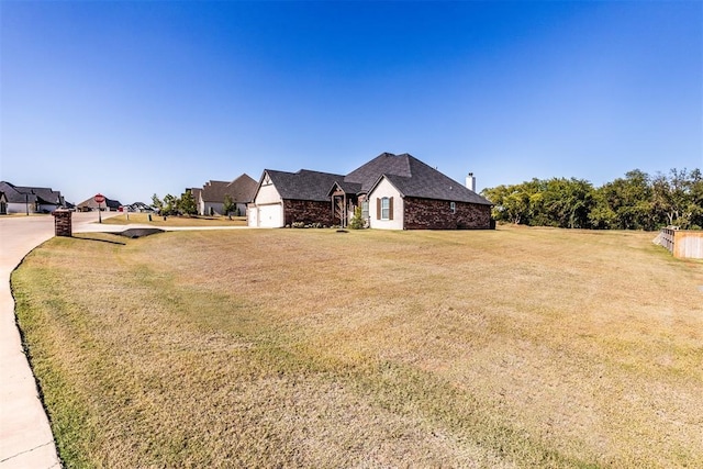 view of front of house with a front yard and an attached garage