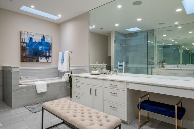 1421 Glenbrook Ter, Nichols Hills, OK 73116 - bathroom featuring a skylight, vanity, and a stall shower