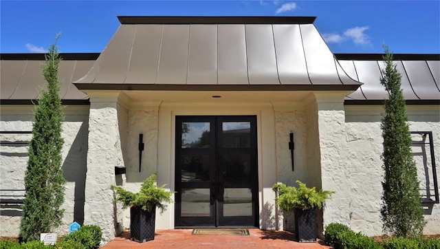 1421 Glenbrook Ter, Nichols Hills, OK 73116 - view of exterior entry with a standing seam roof, french doors, metal roof, and stucco siding