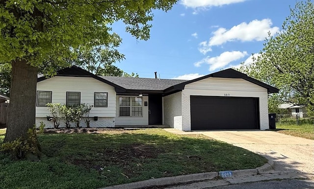 5213 Lombardy Ln, Oklahoma City, OK 73112 - ranch-style house with concrete driveway, an attached garage, roof with shingles, and brick siding