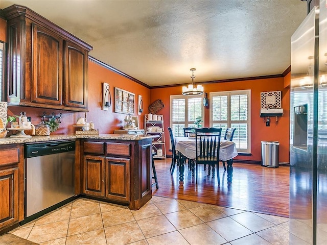 kitchen featuring crown molding, dishwasher, light tile patterned floors, a peninsula, and an inviting chandelier