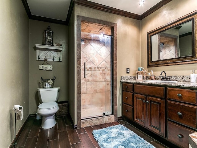 bathroom featuring crown molding, wood finish floors, toilet, baseboards, and a stall shower
