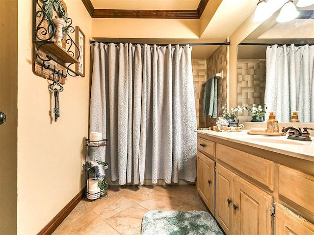 full bathroom with crown molding, vanity, baseboards, and curtained shower
