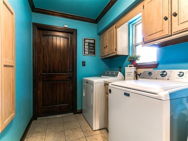 clothes washing area featuring ornamental molding, baseboards, washing machine and clothes dryer, cabinet space, and light tile patterned floors