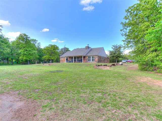 view of front facade featuring a front lawn and a chimney