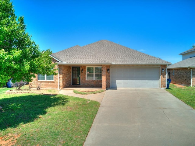 ranch-style home with brick siding, a garage, a front lawn, and driveway