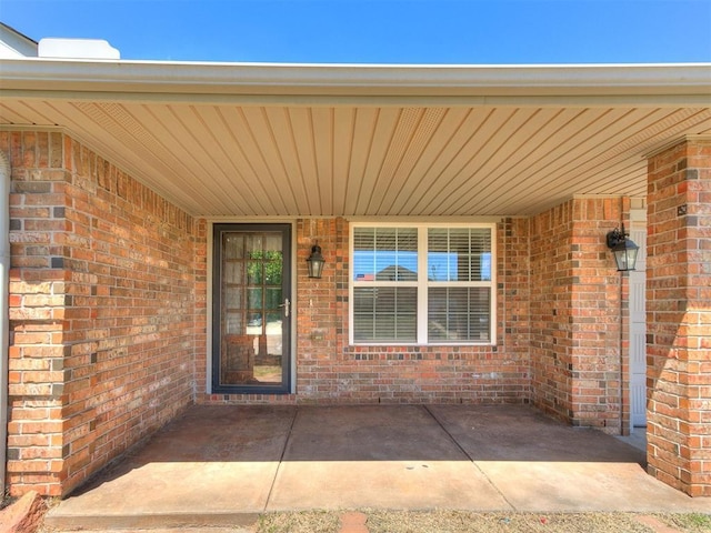 property entrance with brick siding