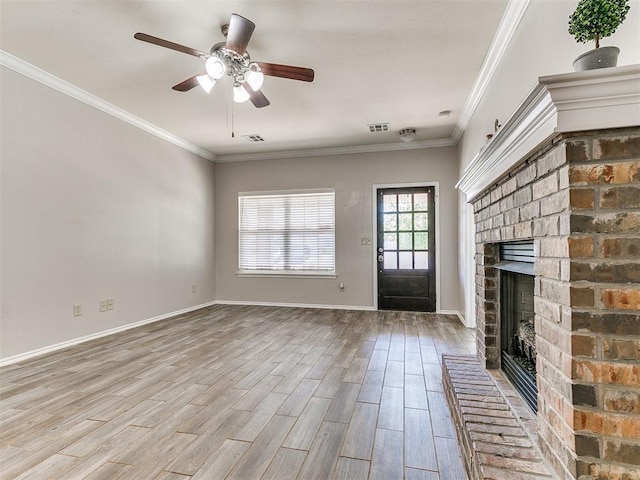 unfurnished living room featuring ceiling fan, a fireplace, ornamental molding, and wood finished floors