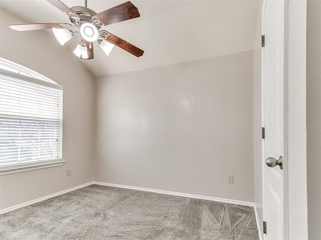 carpeted empty room featuring baseboards, ceiling fan, and lofted ceiling