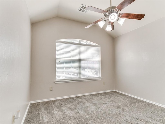 carpeted spare room with visible vents, baseboards, ceiling fan, and vaulted ceiling