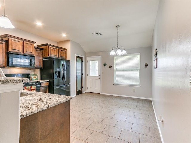 kitchen with baseboards, light stone counters, black appliances, and decorative light fixtures