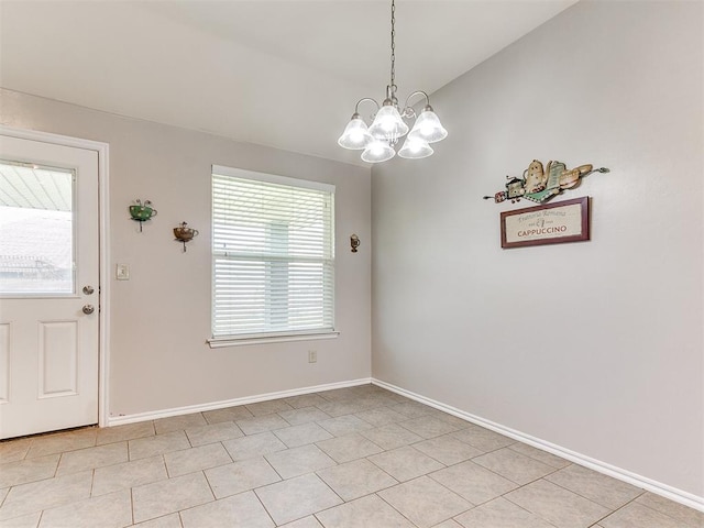 unfurnished dining area featuring light tile patterned floors, baseboards, and a chandelier