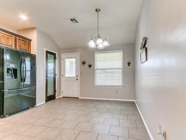 interior space with visible vents, vaulted ceiling, baseboards, an inviting chandelier, and light tile patterned flooring