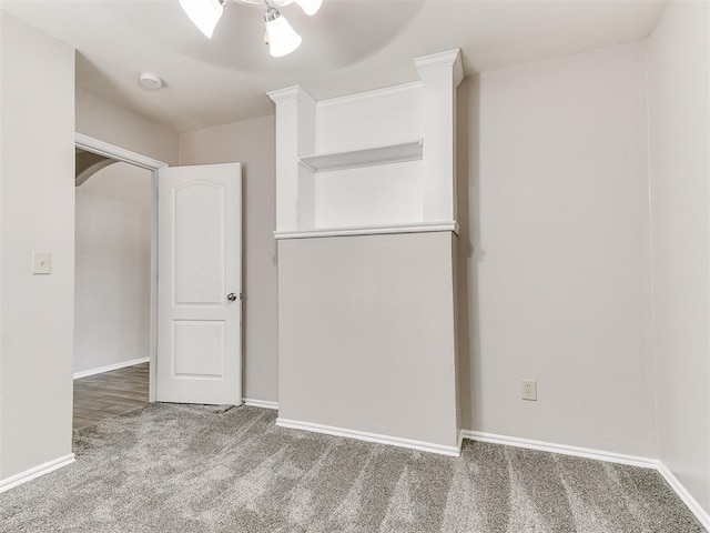 spare room featuring baseboards and carpet flooring