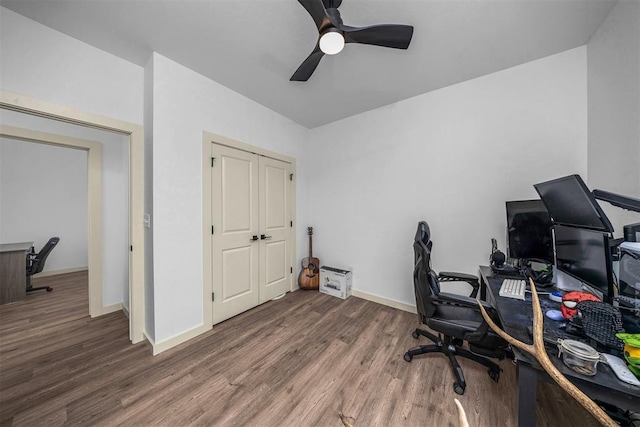 office space with baseboards, wood finished floors, and a ceiling fan