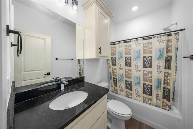 full bath with wood finished floors, vanity, toilet, and shower / tub combo with curtain