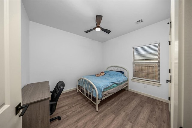 bedroom with visible vents, ceiling fan, wood finished floors, and baseboards
